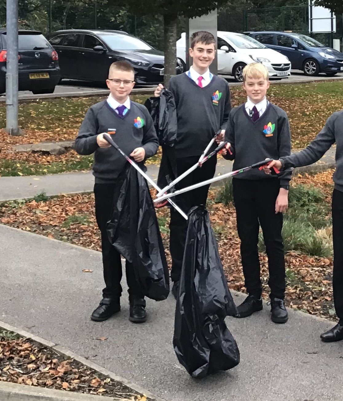 3 students stood out on the street litter picking